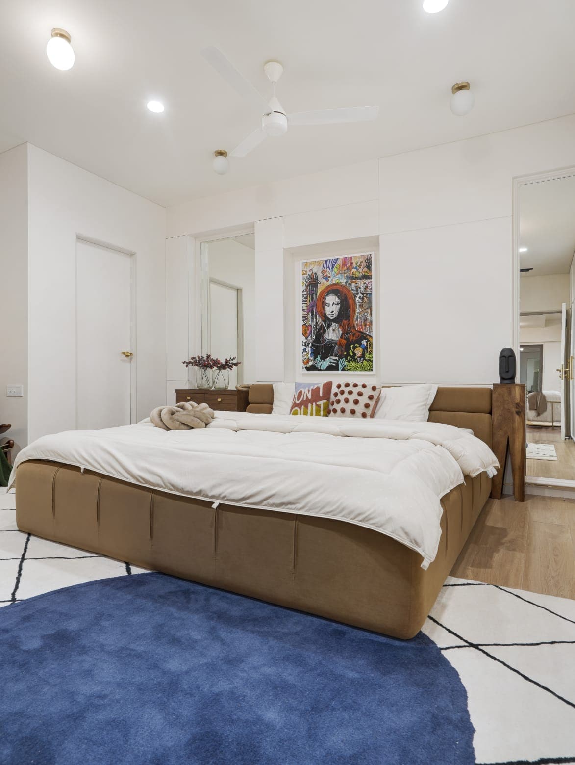 Caramel leather bed in minimal white bedroom