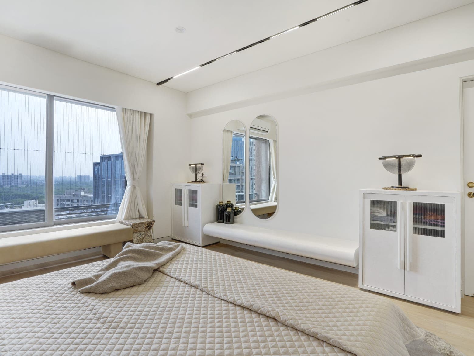 Minimal bedroom with floor-to-ceiling city view windows