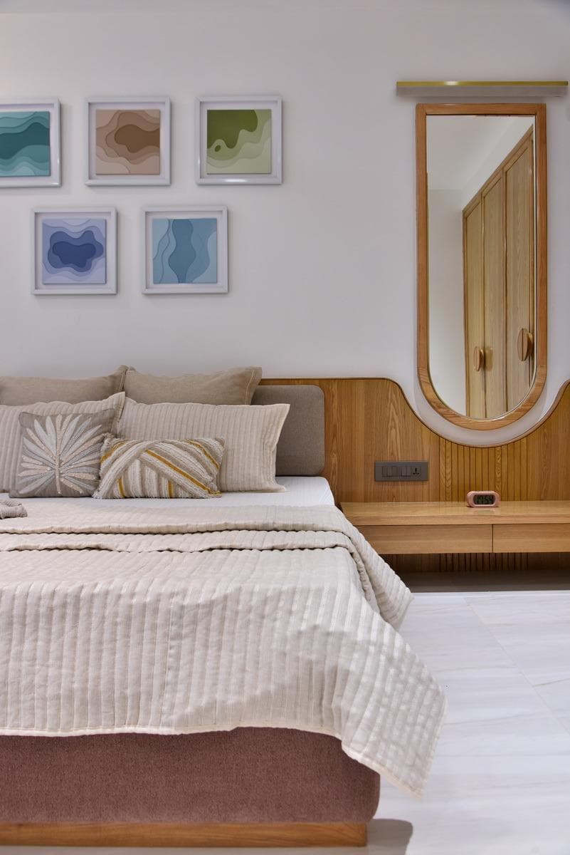 Bedroom corner with curved wood panel and oval mirror