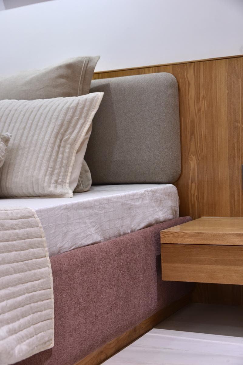 Platform bed corner with teak side panel detail