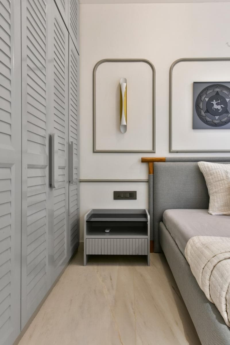 Grey slatted wardrobe beside upholstered seat