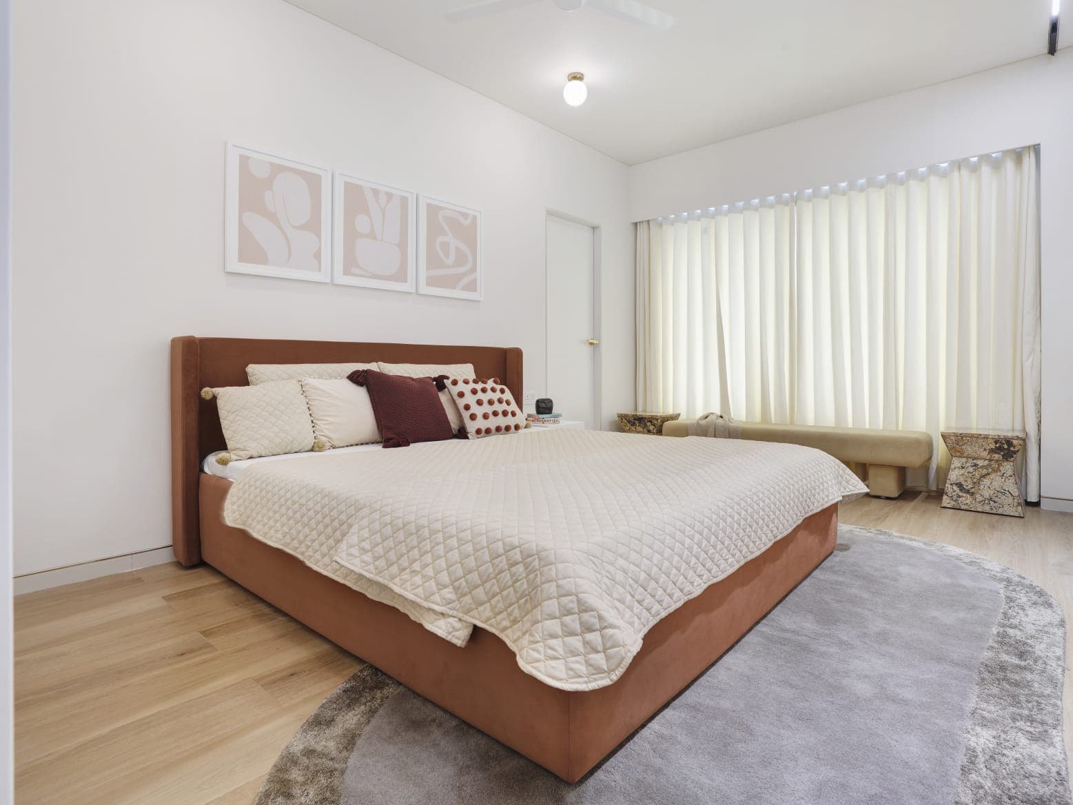 Terracotta fabric bed with neutral linen bedding