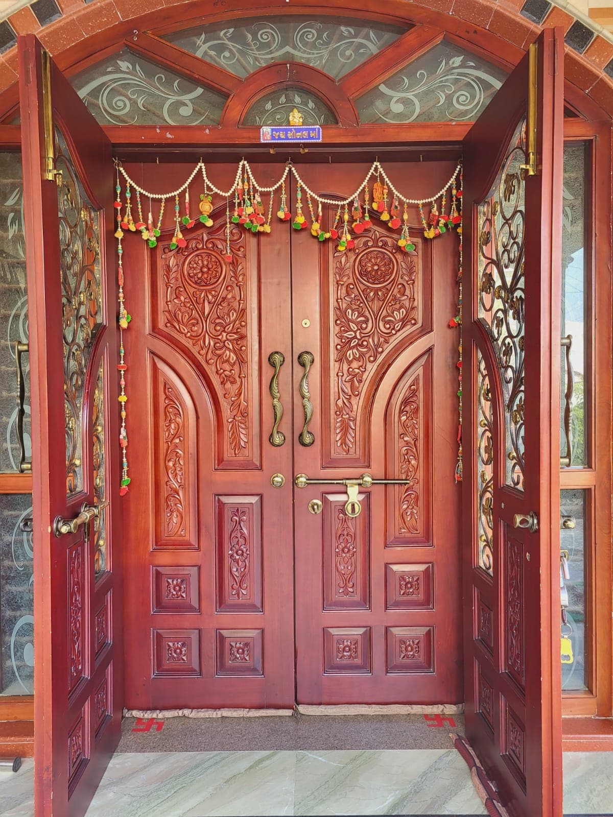Hand-carved traditional double door with brass fittings