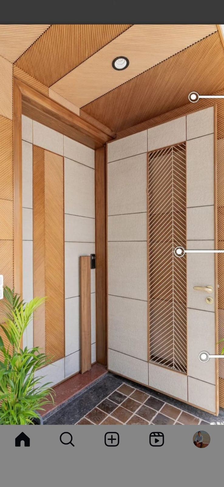 Main door with chevron wood frame and cream padded panel