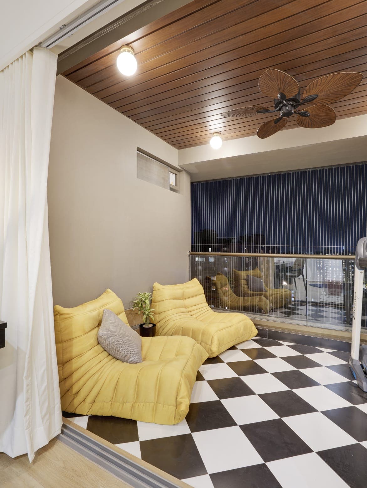 Balcony lounge with yellow loungers and navy slat wall