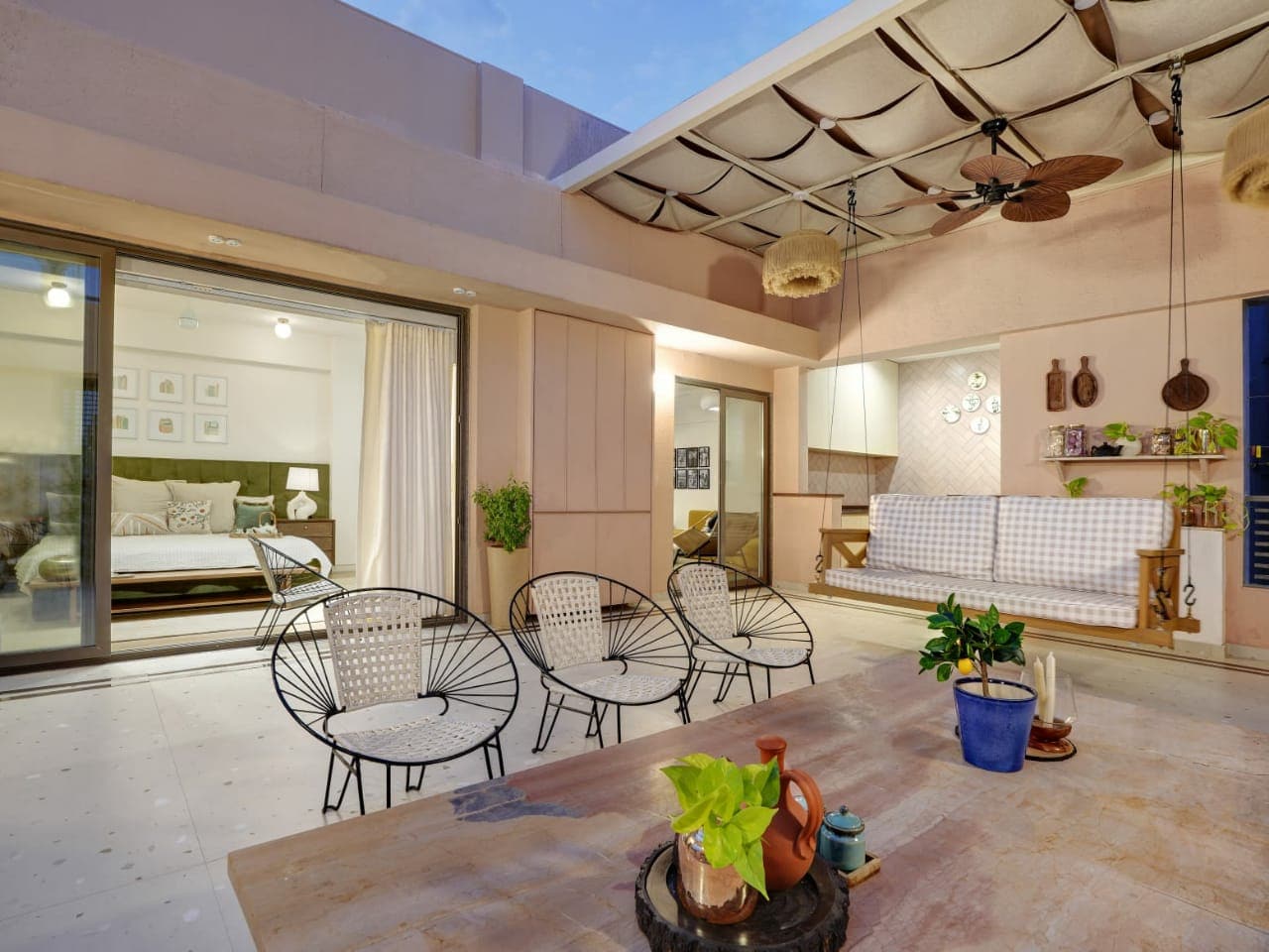 Covered terrace with wicker chairs and wooden ceiling