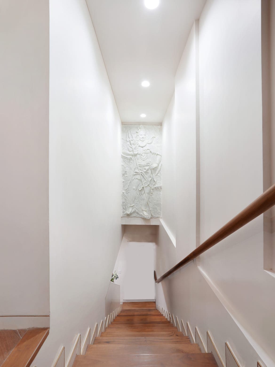 Stair hall with sculpted white relief artwork