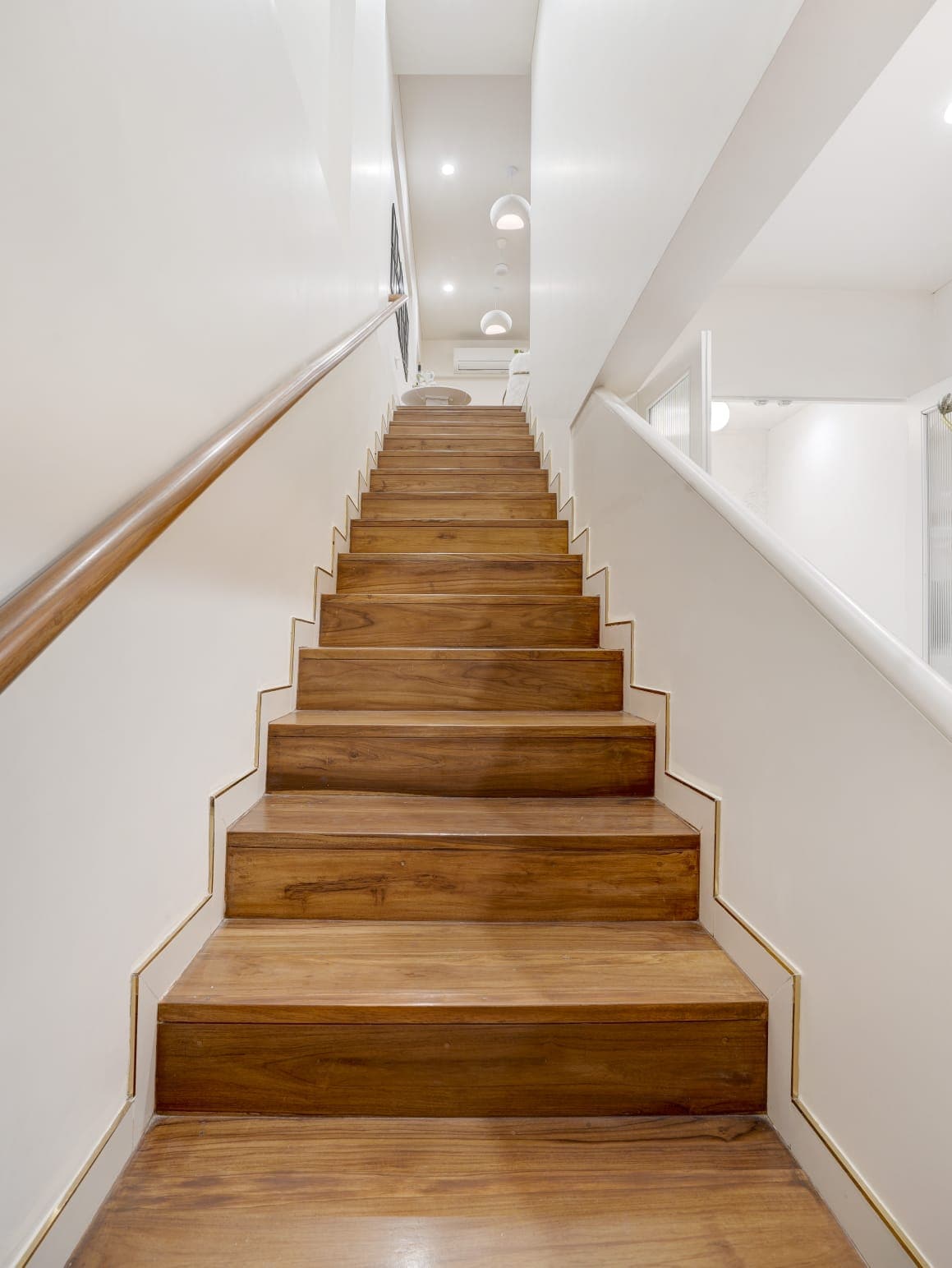Solid teak staircase with brass edge detailing