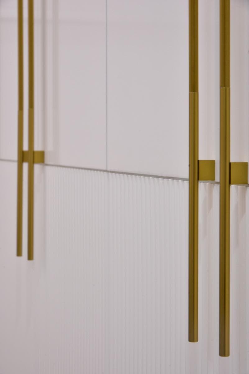 Fluted wardrobe panels with brushed gold bar handles