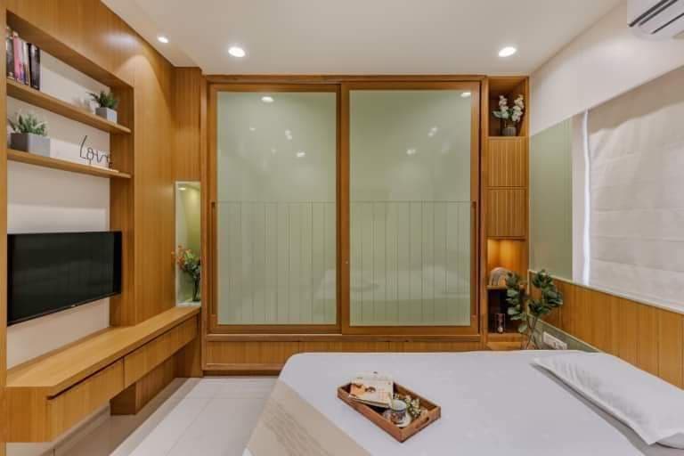 Frosted glass sliding wardrobe with wood TV ledge