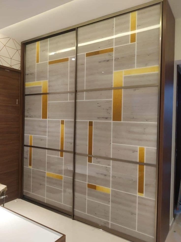 Stone-finish sliding doors with brass geometric bands