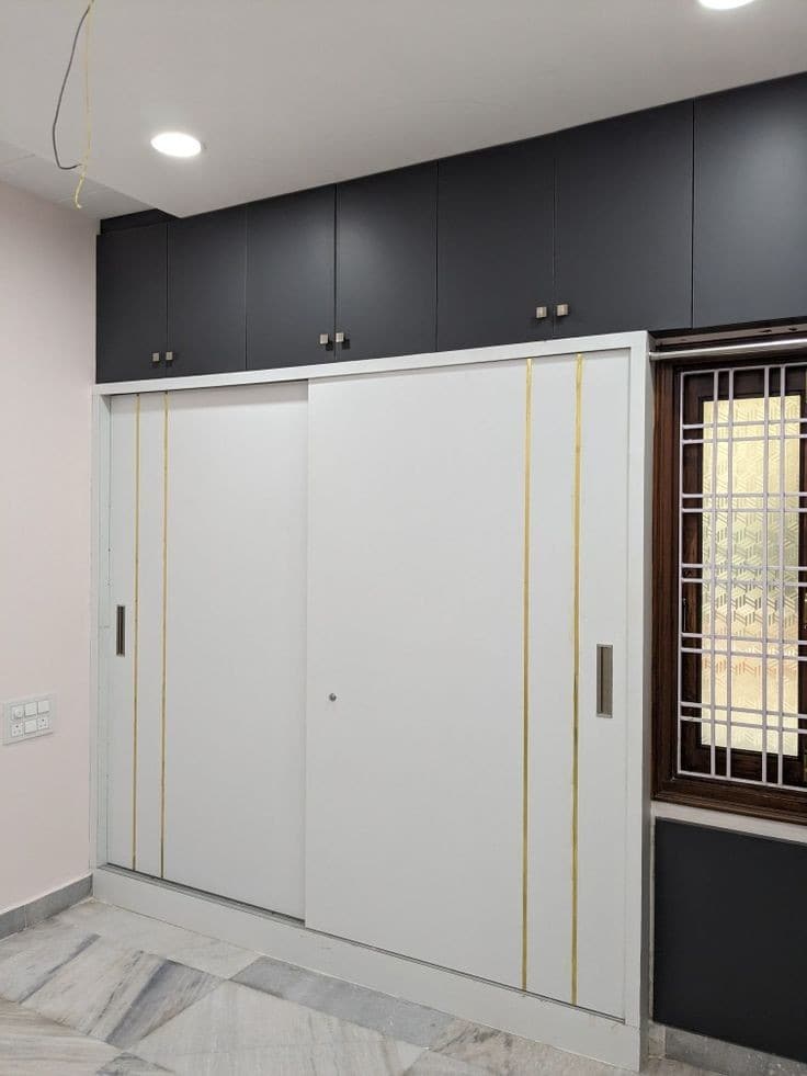 White sliding wardrobe with charcoal overhead cabinets