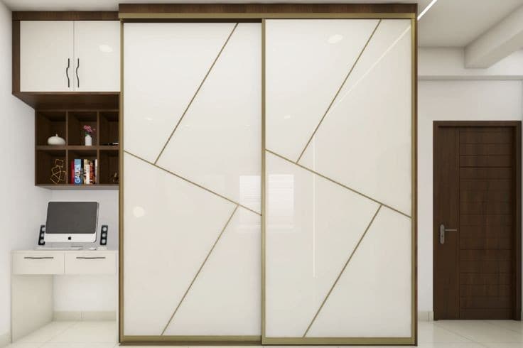 White sliding wardrobe with gold lines beside study desk
